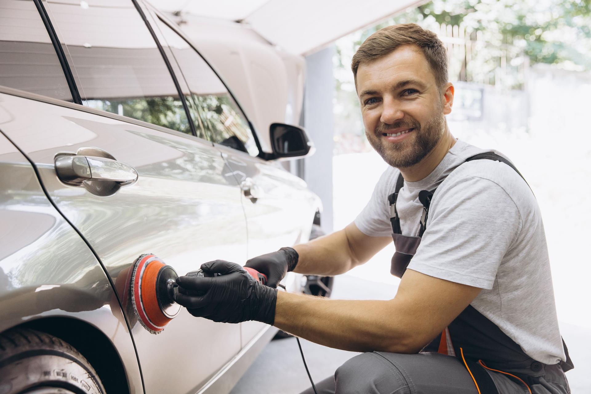 Professional Car Detailing with an Auto Polisher in a Garage Setting
